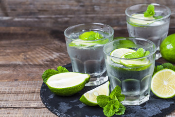 Mojito cocktail in a bur on a rustic table, selective focus