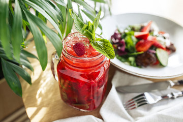 Refreshing red cocktail with strawberries