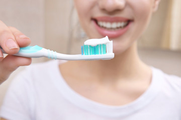 Beautiful woman brushing teeth, closeup