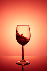 Glass of wine. Red Wine Abstract Splashing. Wine splashing in glass, acrylic background, studio lighting