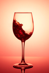 Glass of wine. Red Wine Abstract Splashing. Wine splashing in glass, acrylic background, studio lighting