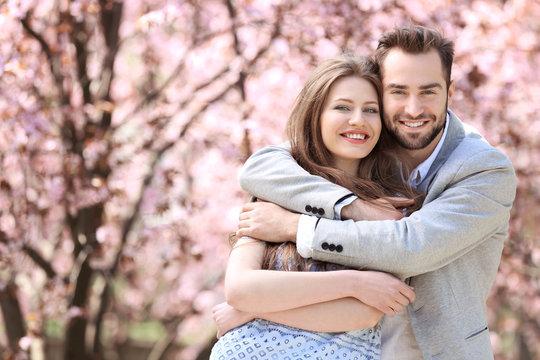 Young lovely couple walking in spring park