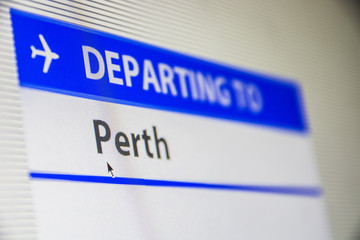 Computer screen close-up of status of flight departing to Perth, Australia