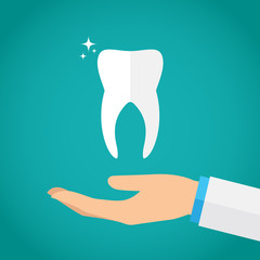 Hand holding tooth