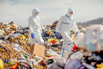 Recycling workers researching on the landfill