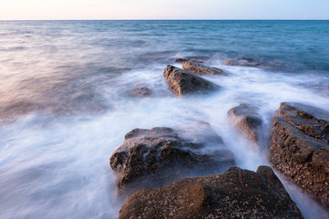 Waves and rocks shore long exposure
