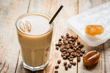 iced coffee with beans for cold summer drink on wooden background