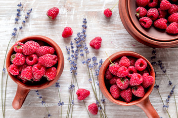 fresh raspberry and dry lavander in rustic design wooden background top view
