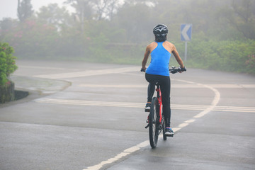 Fototapeta na wymiar cyclist cycling mountain bike on foggy forest trail