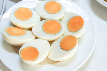 Halves boiled eggs on white dish