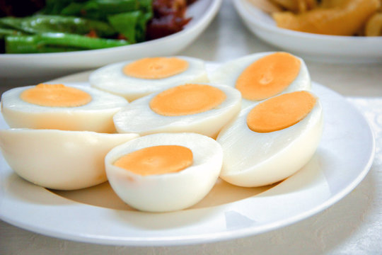 Halves boiled eggs on white dish