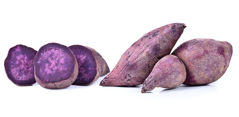 Whole purple yams photographed on a white background.