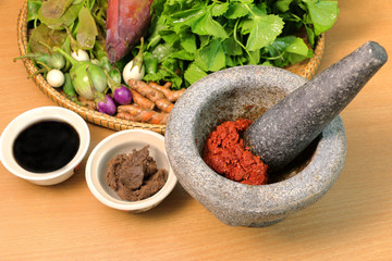 ingredient of curry in mortar mix, curry thai food stye place on wood background