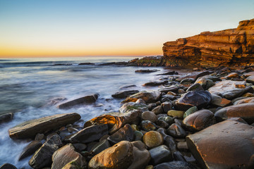 Fototapeta na wymiar Sunset at a rocky beach