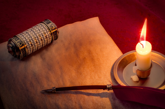 Cryptographic encoding and sending secretes concept with a secret chamber box or cryptex, blank old paper with room for text, quill and a candle illuminating the scene in candlelight, with copy space