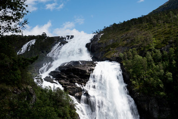 Fototapeta na wymiar Waterfall in mountains of Norway in rainy weather.