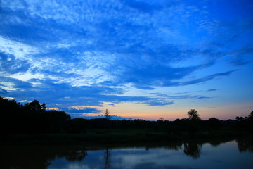 sky in sunset cloud colorful beautiful with silhouette  tree woodland and river reflect in countryside evening on nature