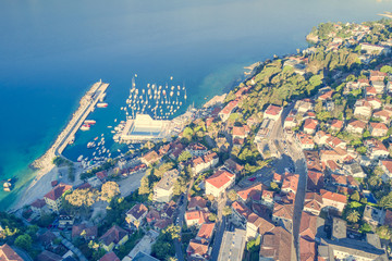 Top view of the city with red roofs and the marina
