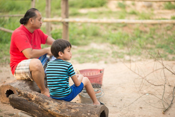 Asain Father and son making barbecue togheter outdoor activity