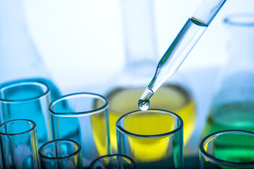Dropping chemical liquid to test tubes 