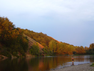 Summer landscape with a man in the water.