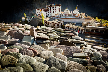 Prayer stones with carved mantras with Tibetan script above the Buddhist monastery of Lamayuru in...