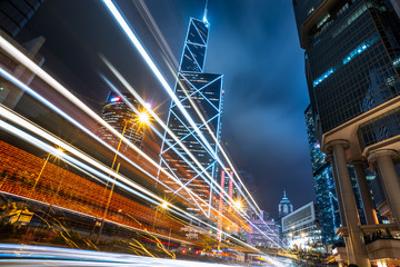 Fototapeta na wymiar light trails on city street with cityscape at night in China.