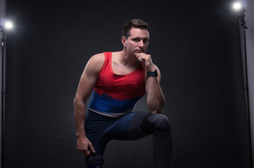 man sportsman athlete posing, prosthetic leg, reflectors lights