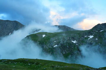 Fototapeta premium Evening fog up the gorge between mountains. Western Caucasus.