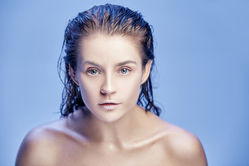 Beautiful woman face portrait close up on blue