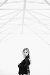 The beautiful girl stands in the center of room