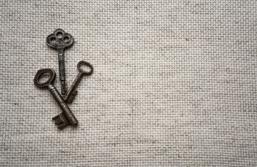 Vintage keys on natural canvas background  with a space for text.