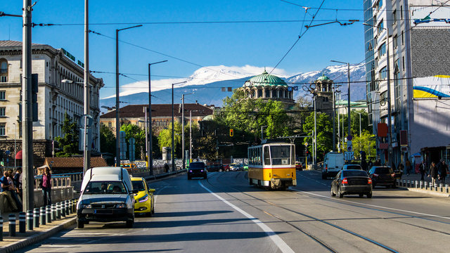 The church "Sveta Nedelya" cathedral of the Sofia bishopric. Traffic Boulevard Knyaginya Mariya Luiza, in the background the Vitosha Mountain. Bulgaria