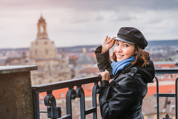 Happy woman travel in Europe, standing on the overlooking site against beautiful Dresden cityscape...