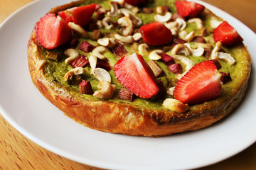 Matcha green tea cake with strawberry, rhubarb, Cashew nuts
