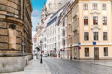 Fotobehang A narrow street in the historic center of Dresden in the morning without pedestrians and cars © EdNurg