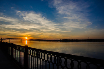 Fototapeta na wymiar Sunset over the river above the bridge