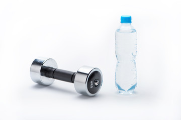 metallic dumbbell and bottle with water isolated on white. drink water, equipment sport and healthy living concept