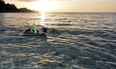 young athlete triathlon in front of a sunrise