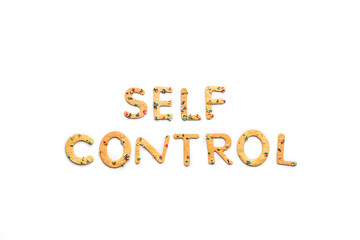 Naklejka premium Top view of self control lettering made from sweets isolated on white, healthy living concept