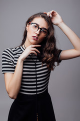 Portrait of beauty girl in eyeglasses on grey background
