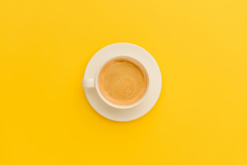 Top view of cup of fresh hot coffee isolated on yellow