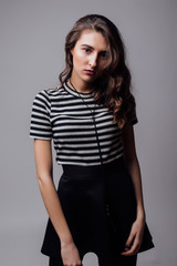 Smiling woman posing with glasses over the grey background