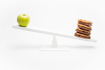 apple and chocolate cookies on swing isolated on white, healthy lifestyle concept
