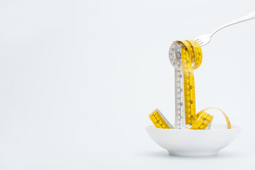 measuring tape on fork isolated on white, healthy living concept