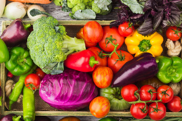 Set of raw vegetables in the wooden tray