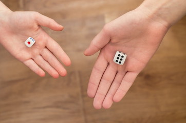 Naklejka premium Dice in the palms of the hands