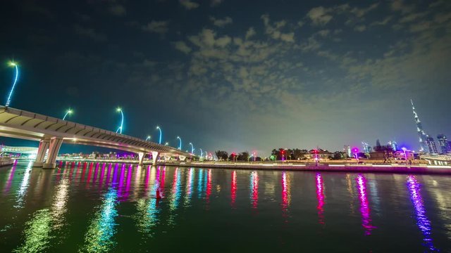 night illumination dubai canal reflection downtown crossing bridge panorama 4k time lapse uae
