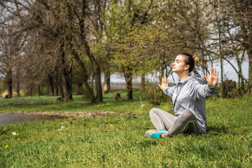 girl in sportswear doing yoga in nature