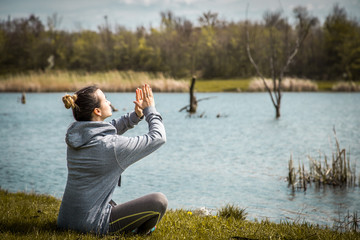 girl in sportswear doing yoga in nature